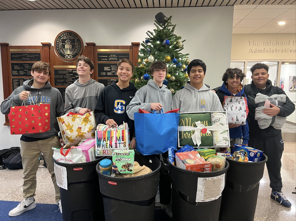  Students gather together with all of the donations right before delivering them to families in need.